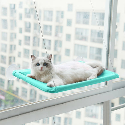 Mintgroene raamhangmat met zuignappen met een kat die languit in de zon ligt