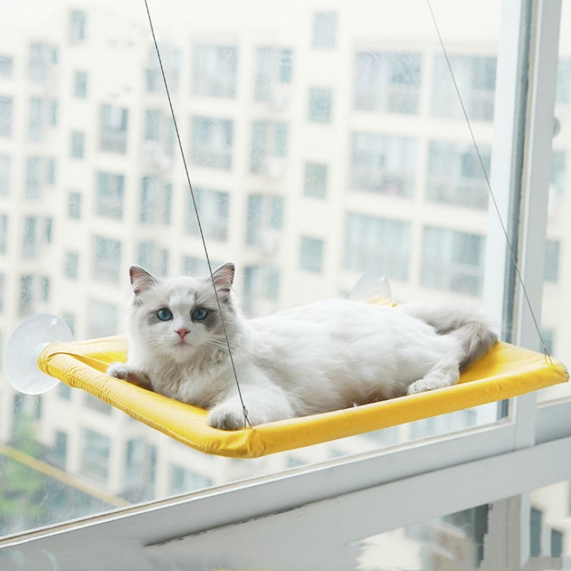 Gele raamhangmat met zuignappen met een kat die uit het raam kijkt